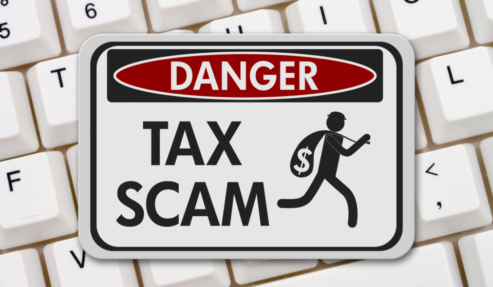 Tax scam danger sign, A black and white danger sign with text Tax Scam and theft icon on a keyboard