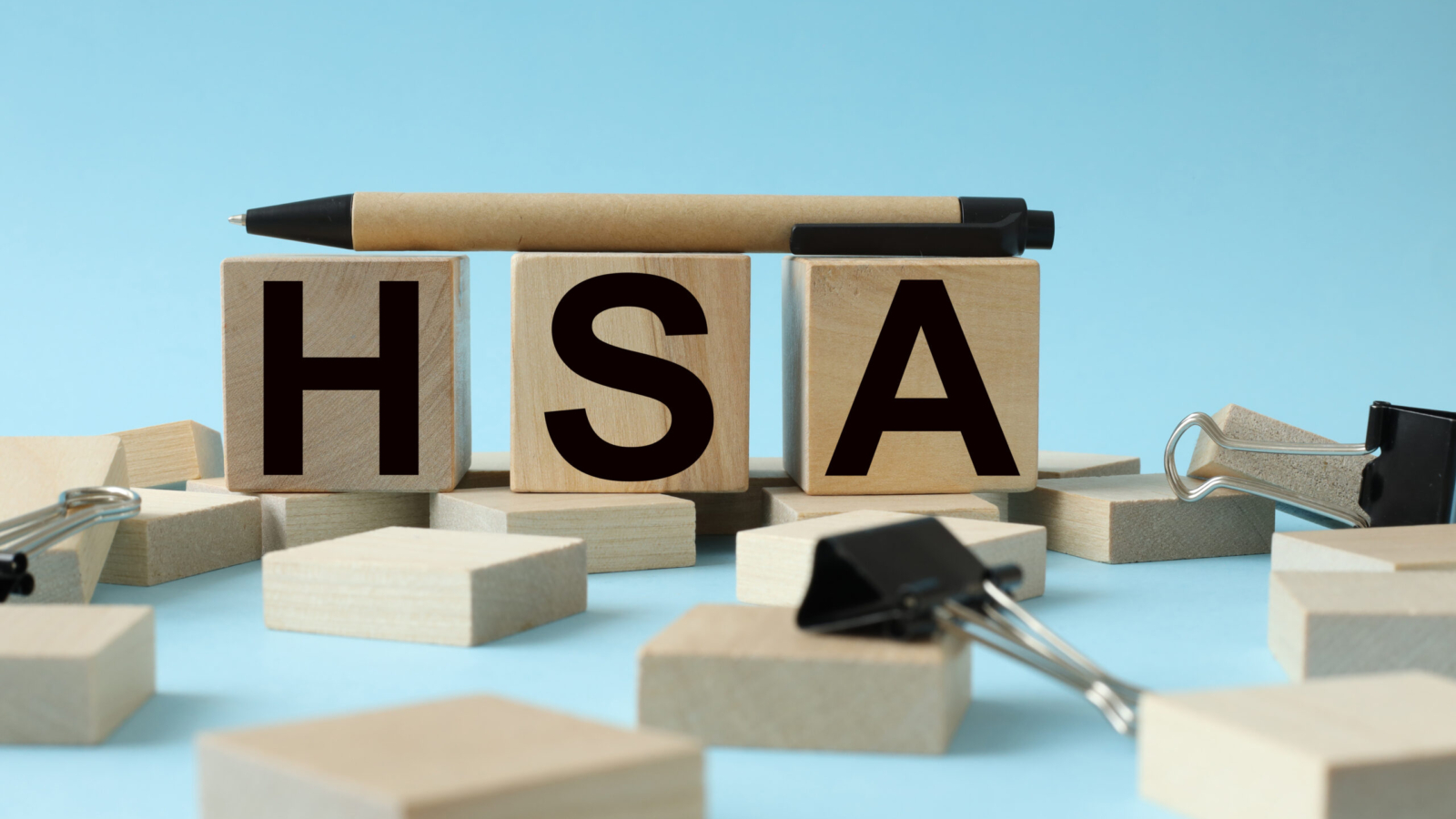 Wooden cubes with words HSA Health Savings Account Business and HSA concept.