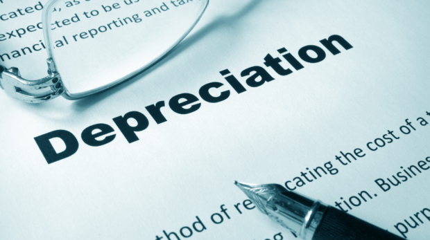 Paper with sign Depreciation and a pen. Business concept.