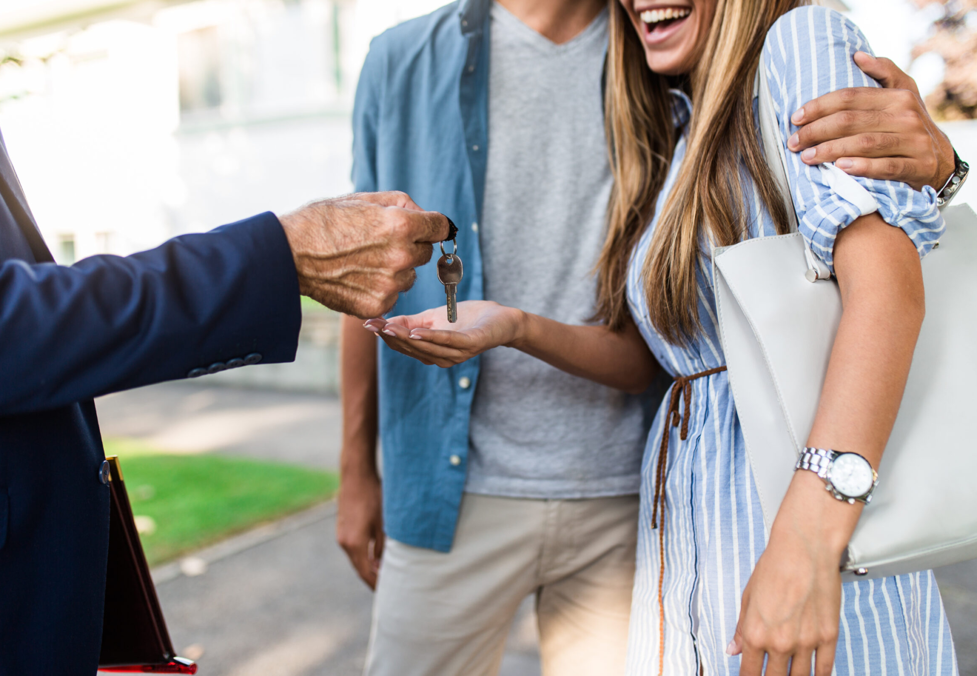 Young happy couple talking with real estate agent and buying a new house.